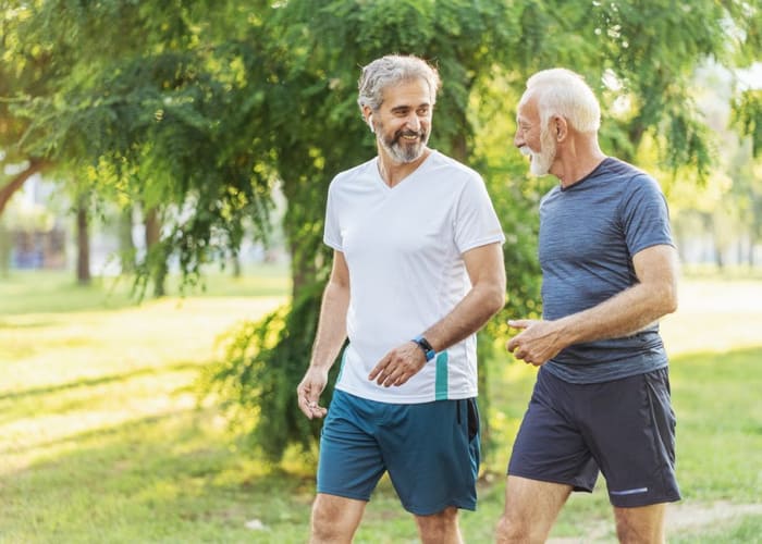 men-walking-and-talking-while-walking-outside