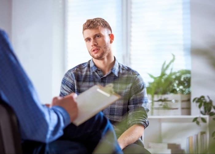 male college student in counseling session