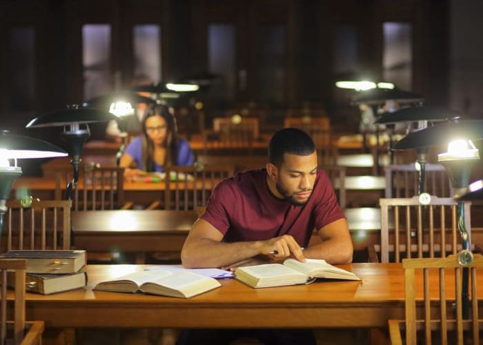young-man-preparing-for-test-in-library-to-reduce-anxiety