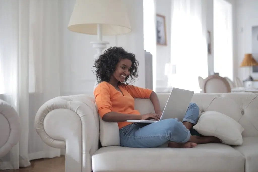 Woman-sitting-on-white-couch-using-laptop-computer-3960127-1024x683-1.jpg