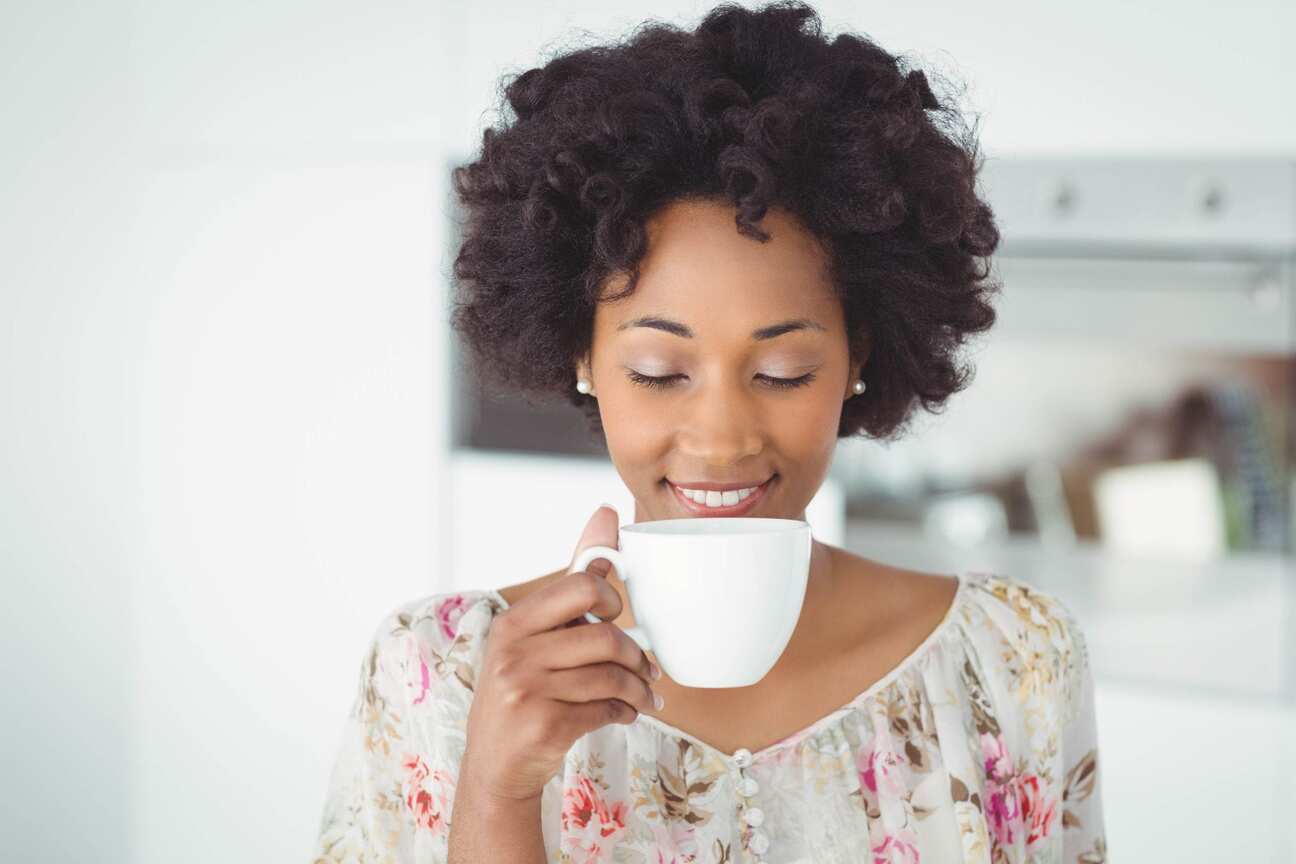 Canva-Peaceful-woman-holding-white-mug.jpg